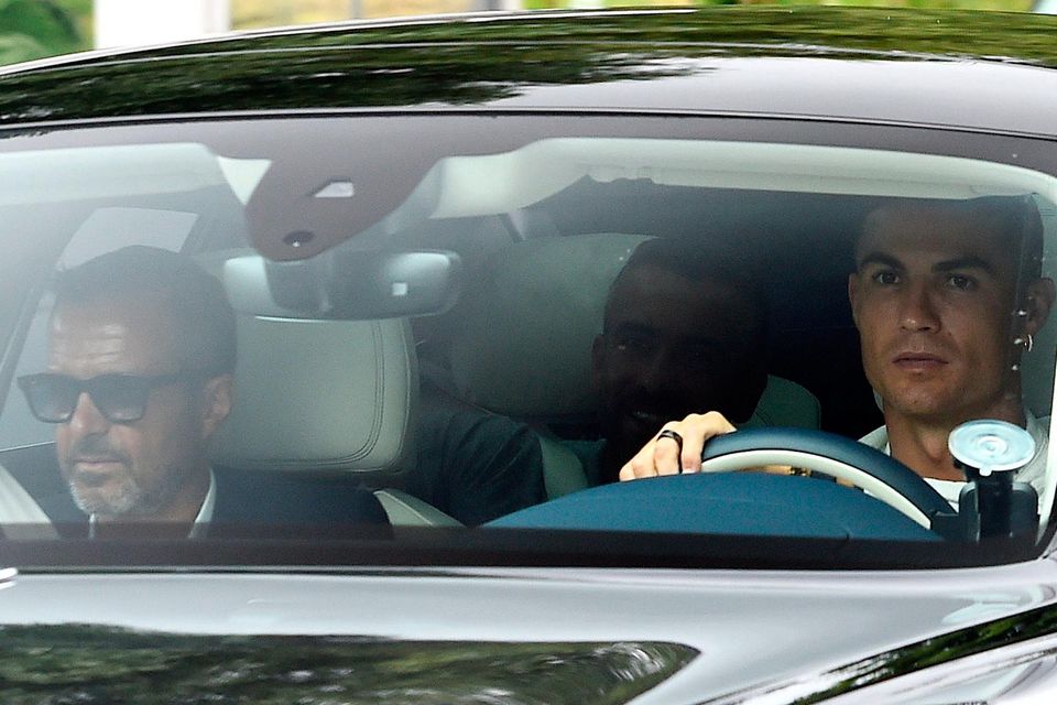 Cristiano Ronaldo, right, arrives at Manchester United's training ground yesterday. Photo: PA Wire