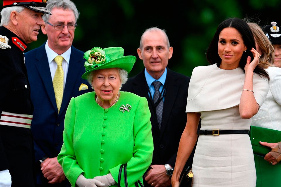 Meghan Markle stuns in chic cape Givenchy dress for first solo engagement  with Britain's Queen Elizabeth | Irish Independent