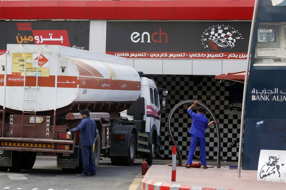 Workers refuel the tank at a petrol station in Saudi Arabia (Amr Nabil/AP)