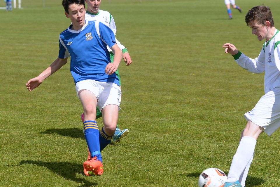 19/05/15. Miquel Barry tackles Liam Tracey during the Under 15s soccer final between Colaiste Phadraig CBS and Templeouge College at Peamount Utd.
Pic: Justin Farrelly.