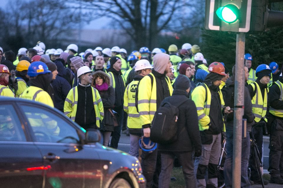 Workers outside the plant after the bomb scare this morning