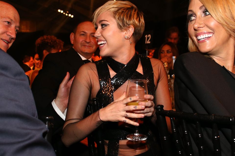 Singer Miley Cyrus (C) and Tish Cyrus (R) attend amfAR LA Inspiration Gala honoring Tom Ford at Milk Studios