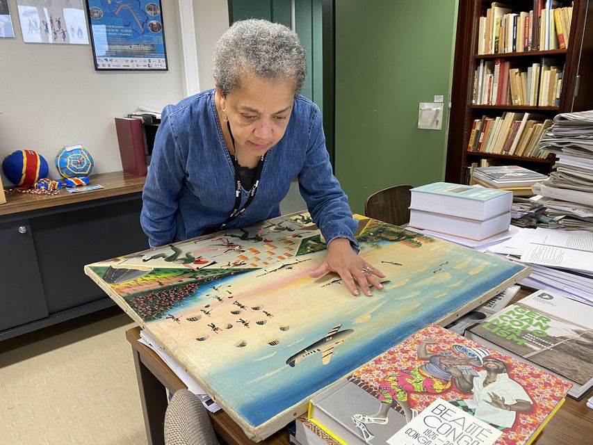 Dr Bambi Ceuppens examining the painting in her office at the Africa Museum