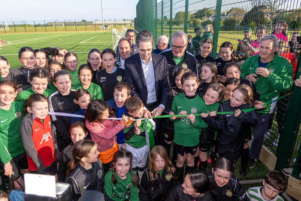 Taoiseach Simon Harris cuts the ribbon on the new pitch at Greystones United. Photo: Leigh Anderson