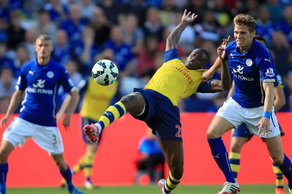 Leicester City's Dean Hammond (right) pulls back Arsenal's Yaya Sanogo (centre)