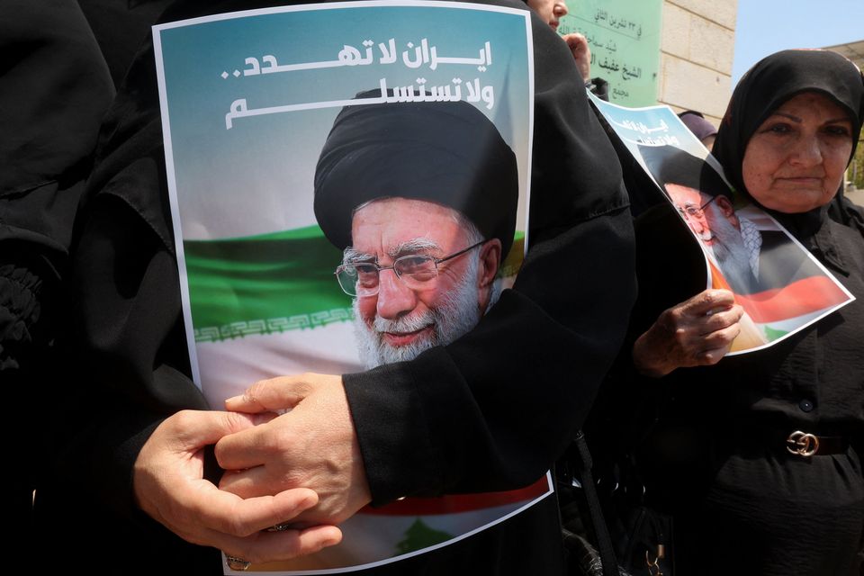 A demonstrator holds a poster depicting Iran's Supreme Leader Ayatollah Ali Khamenei during a rally in solidarity with Iran. Photo: Reuters