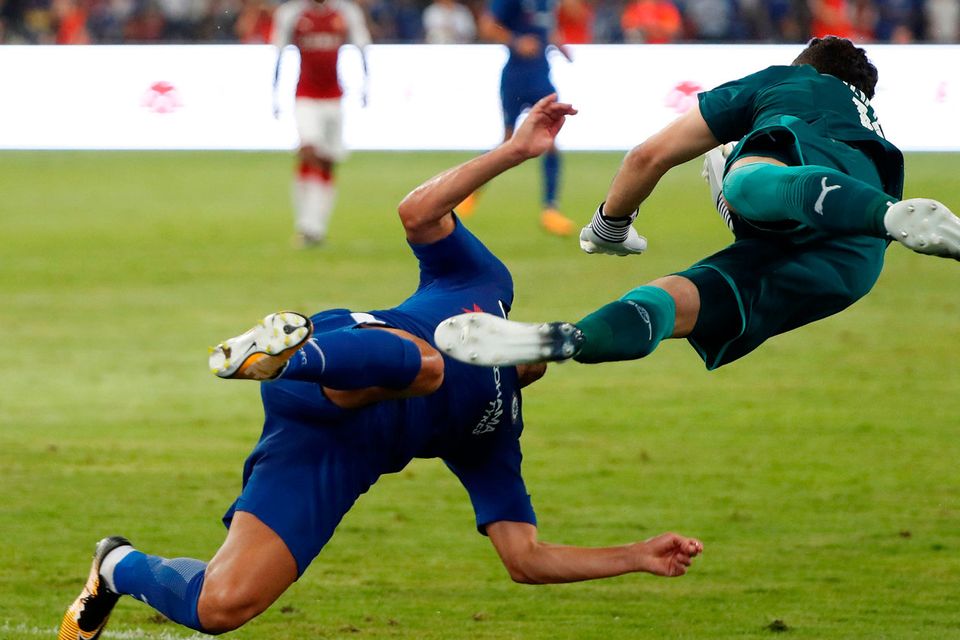 Chelsea's Pedro collides with Arsenal's David Ospina. REUTERS/DAMIR SAGOLJ