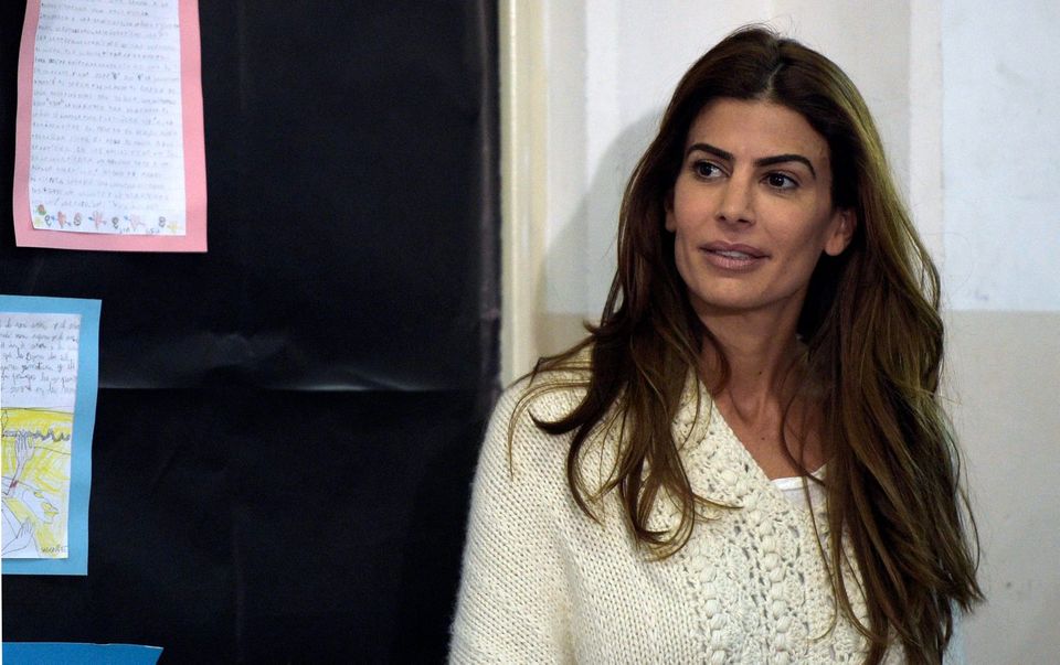 Juliana Awada wife of Buenos Aires Mayor and presidential candidate for "Cambiemos" party Mauricio Macri waits to her husband while voting at a polling station in Buenos Aires on October 25, 2015