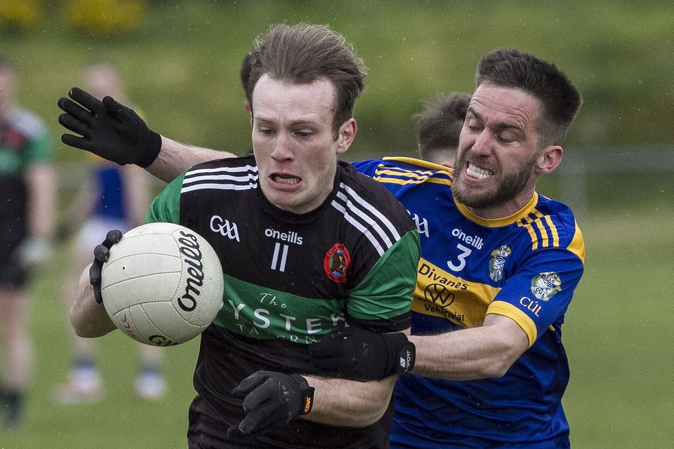 A hair-raising encounter between Churchill centre forward Liam O'Donnell as he holds possession in spite of the challenging Cordal full-back, Jamie Cahill in their County Senior Football League Division 3 game at Páirc an Cúlac in Cordal on Sunday. Photo by John Reidy
