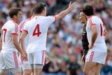 thumbnail: Tyrone players Joe McMahon, 12, Cathal McCarron, 4, Dermot Carlin, left, and Conor Gormley remonstrate with referee Maurice Deegan after he awarded a penelty to Mayo