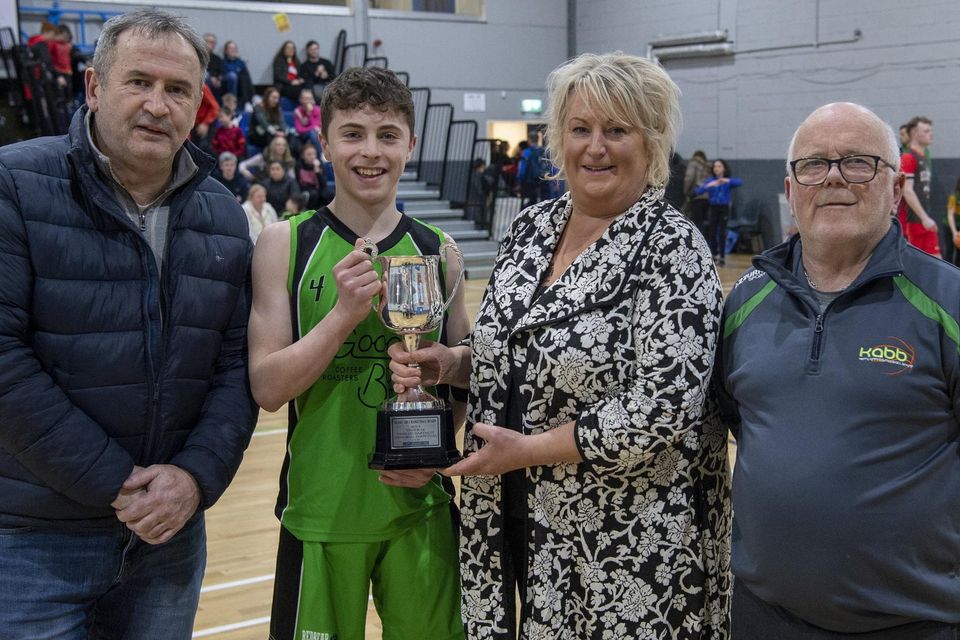 Maura Hartnett and Brendan Hartnett, along with the KABB's Mike Fleming, present the Padraig Harnett Memorial Cup to Sean McAuliffe after Rathmore Ravens won the Boys U-16 Cup final at the KABB Juvenile Basketball Cup finals at the Tralee Sports Complex. Photo by Domnick Walsh