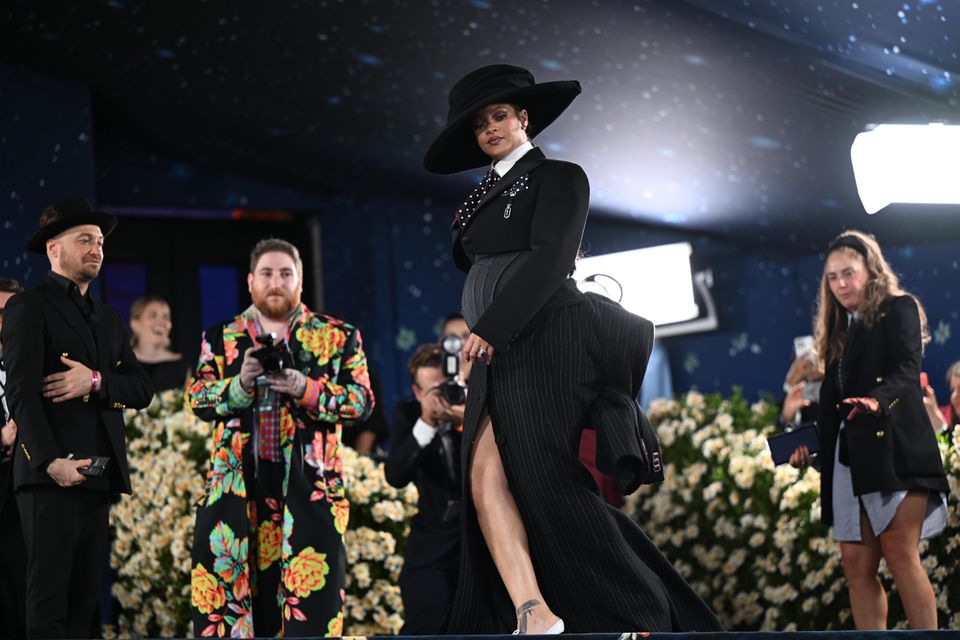 Rihanna announced her pregnancy during the Met Gala in May, where she appeared in a pinstripe look and a huge hat, with her baby bump on display (Matt Crossick/PA)