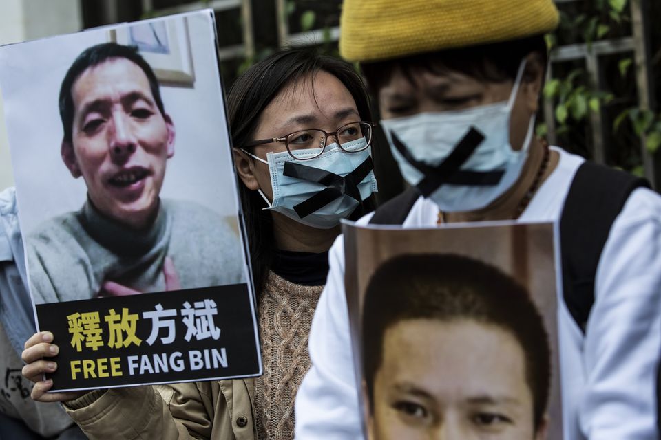An activist holds a photo of Covid campaigner Fang Bin in 2020. Photo: Getty Images