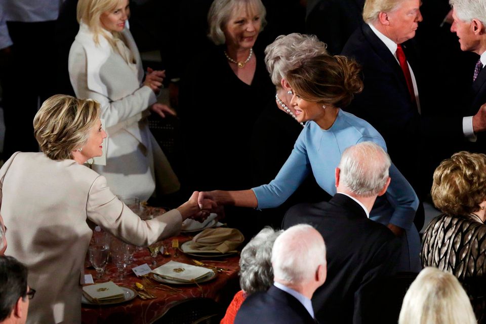 Former Democratic U.S. presidential nominee Hillary Clinton greets First lady Melania Trump as her husband Bill Clinton speaks with President Donald Trump during the Inaugural luncheon at the National Statuary Hall in Washington, U.S, January 20, 2017.  REUTERS/Yuri Gripas