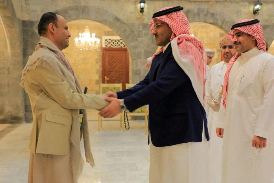 The head of the Houthi Supreme Political Council, Mahdi al-Mashat, shakes hands with Saudi ambassador to Yemen Mohammed Al-Jaber at the Republican Palace in Sanaa, Yemen. Photo: Reuters