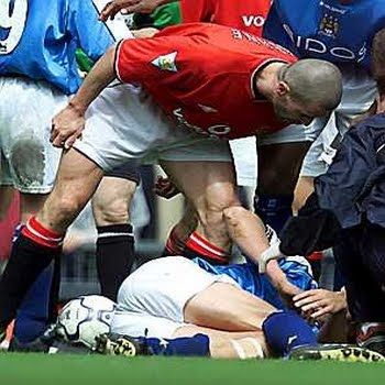 Roy Keane stands over Alf Inge Haaland during a Manchester derby clash in 2000