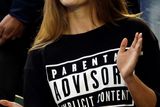 thumbnail: Kim Sears, fiancee of Andy Murray of Britain, applauds before his mens singles final against Novak Djokovic, wearing a 'Parental Advisory Explicit Content' slogan top, in response to the swearing controversy at the previous match