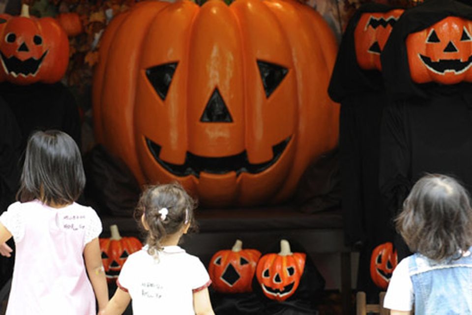 Children look at a pumpkin display at the Marunouchi shopping district in central Tokyo, Getty Images