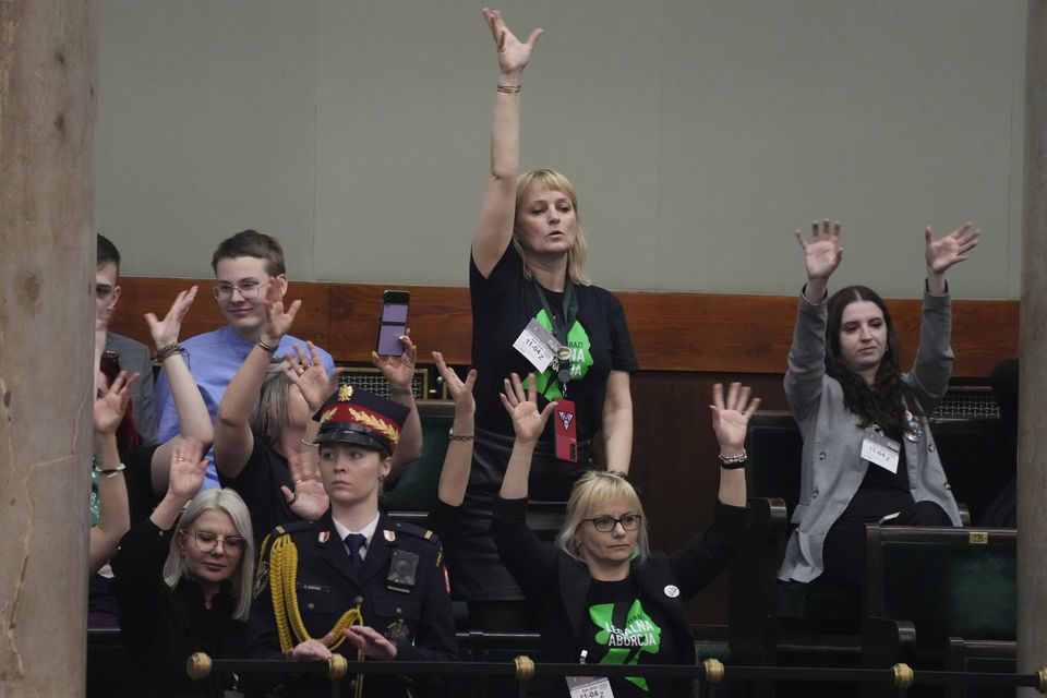 Abortion rights activists react during a debate in the Polish parliament from the gallery of the assembly, in Warsaw, Poland (Czarek Sokolowski/AP)