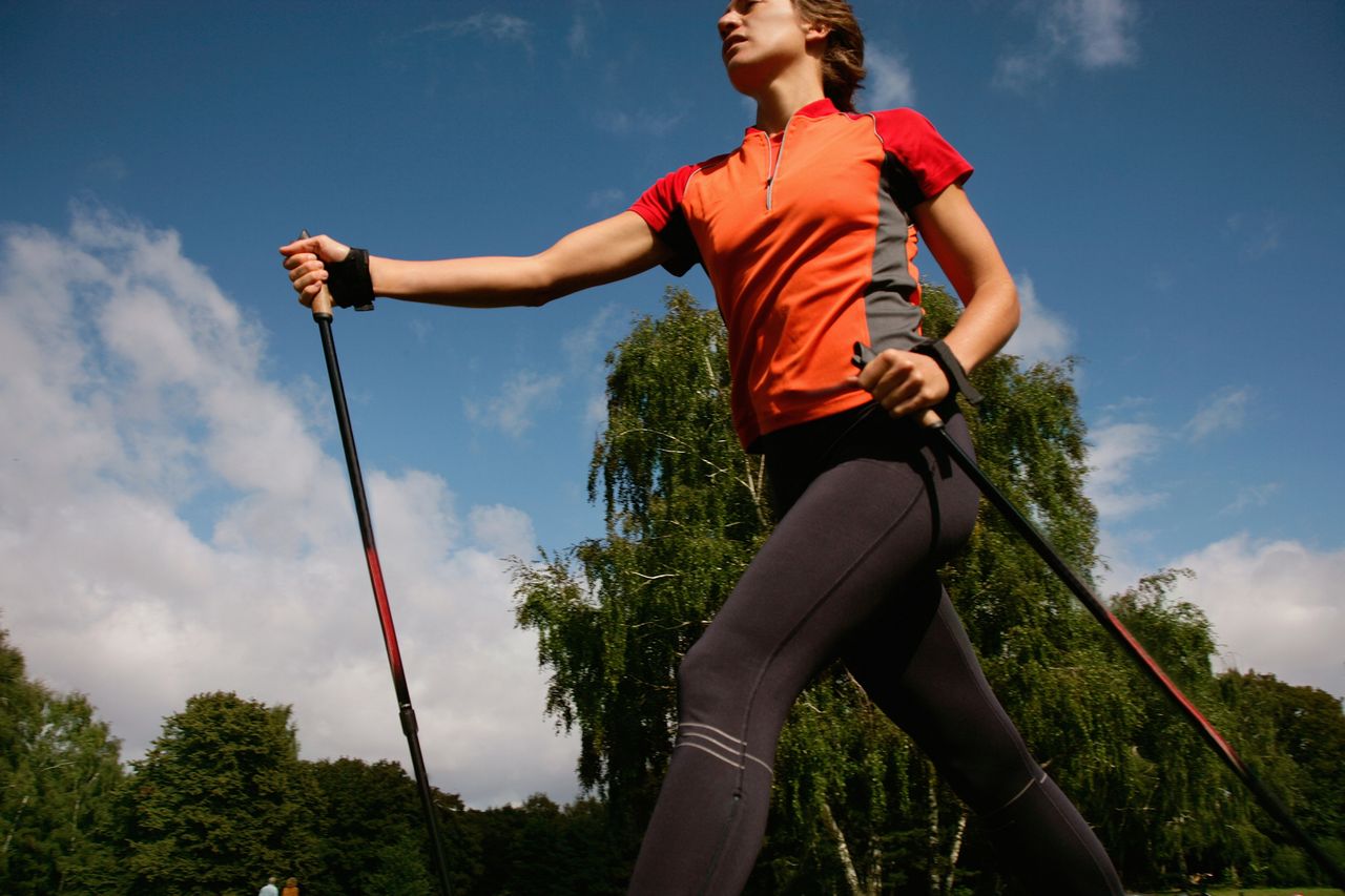 Premium Photo  Girl in sport clothes training pole dance in a studio close  up shot