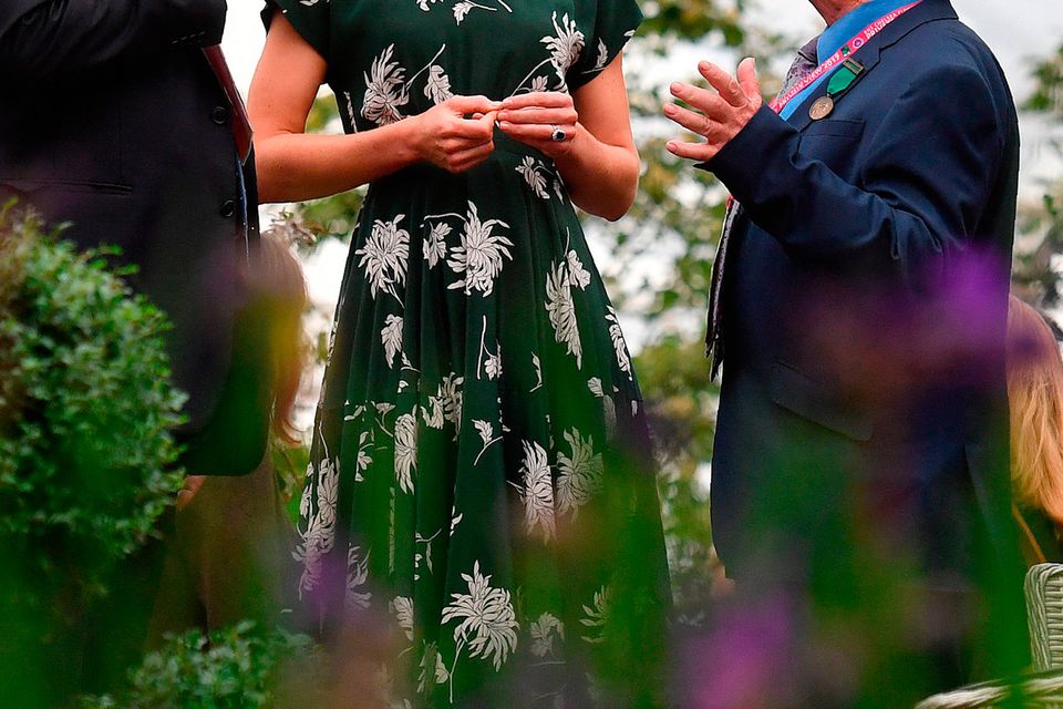 Catherine, Duchess of Cambridge (C) talks with exhibitors as she views a parterre at the Hillier garden display at the RHS Chelsea Flower Show press day at Royal Hospital Chelsea on May 22, 2017 in London, England