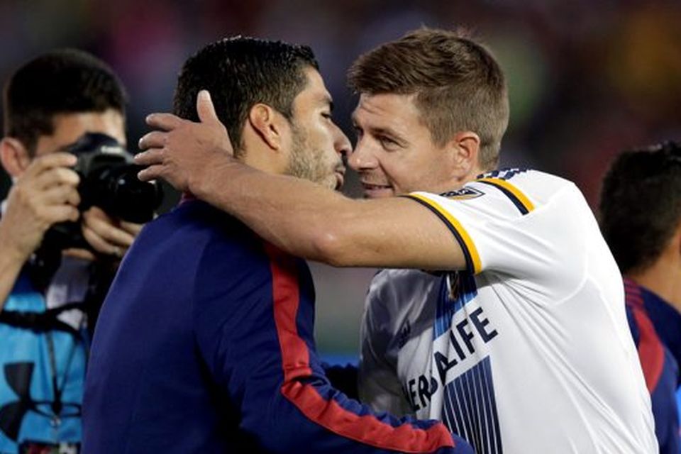 Los Angeles Galaxy's Steven Gerrard, right, of England, hugs former teammate FC Barcelona's Luis Suarez before an International Champions Cup soccer match at Rose Bowl, Tuesday, July 21, 2015, in Pasadena, Calif. The two played for English club Liverpool FC. (AP Photo/Jae C. Hong)