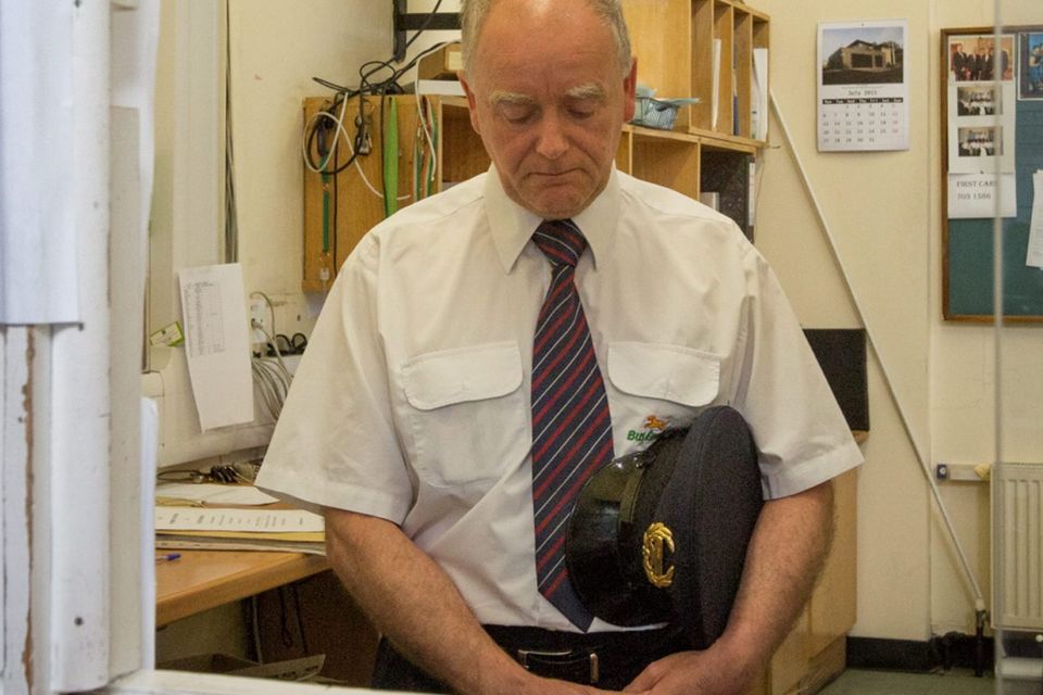 Bus Inspector Joe Cunningham joins a minute’s silence at the Bus Éireann in Broadstone, Dublin.