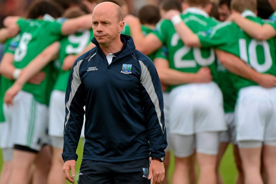 Having issued his final instructions, Peter Canavan makes his way to the team dugout as the Fermanagh players form a huddle and prepare to face Down in the 2012 Ulster championship at Brewster Park