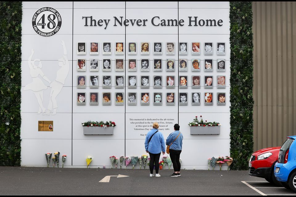Passers-by pay their respects in the car park at the Butterly Business Park in Artane, the site of the Stardust tragedy in 1981 where 48 people lost their lives. Photo: Steve Humphreys