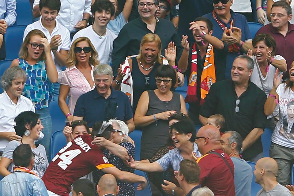 AS Roma's Alessandro Florenzi (bottom L) celebrates with relatives on the tribune after scoring against Cagliari during their Italian Serie A soccer match at the Olympic stadium in Rome