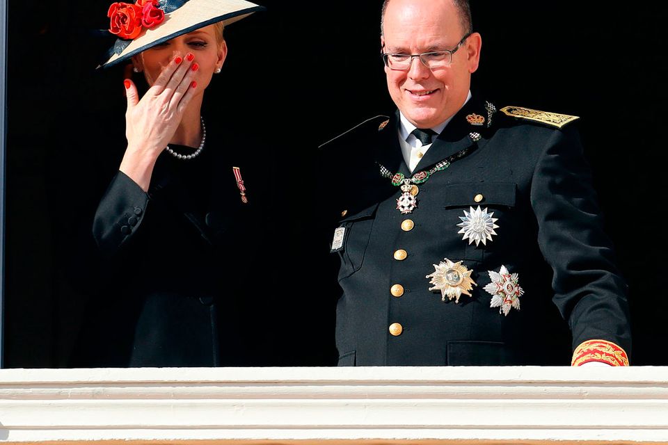 Prince Albert II of Monaco (R) and Princess Charlene of Monaco (L) appear on the balcony of the Monaco Palace during the celebrations marking Monaco's National Day