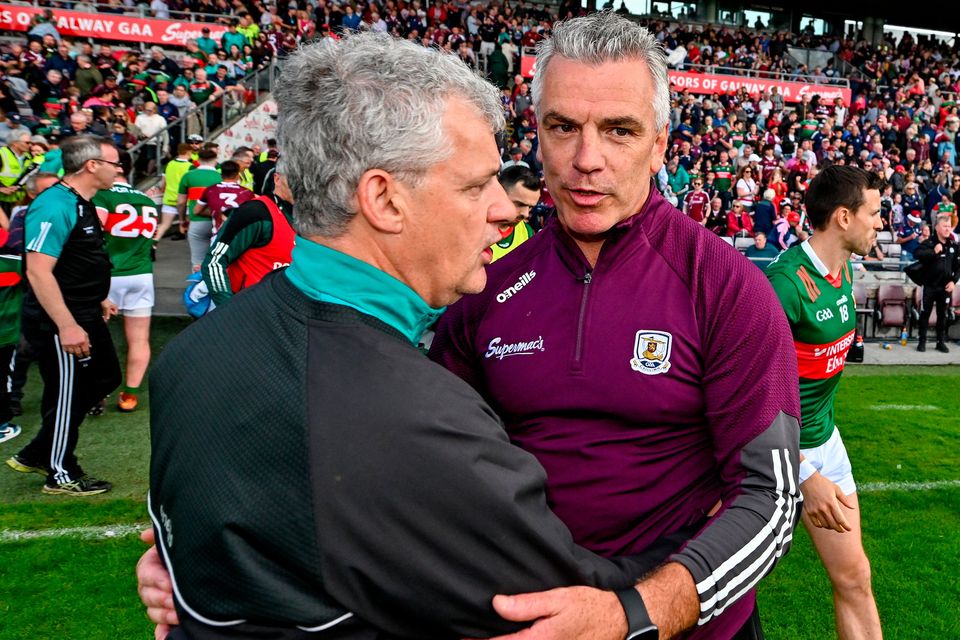 Galway manager Pádraic Joyce, right, and Mayo boss Kevin McStay embrace after last year's All-Ireland preliminary quarter-final. Whenever the two sides meet there's plenty at stake. Photo: Seb Daly/Sportsfile