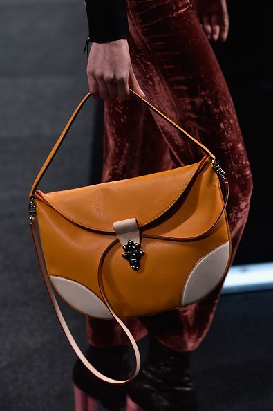 A model, bag detail, walks the runway during the Louis Vuitton