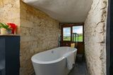 thumbnail: En-suite bathroom with bath overlooking the surrounding countryside. Photo: Airbnb
