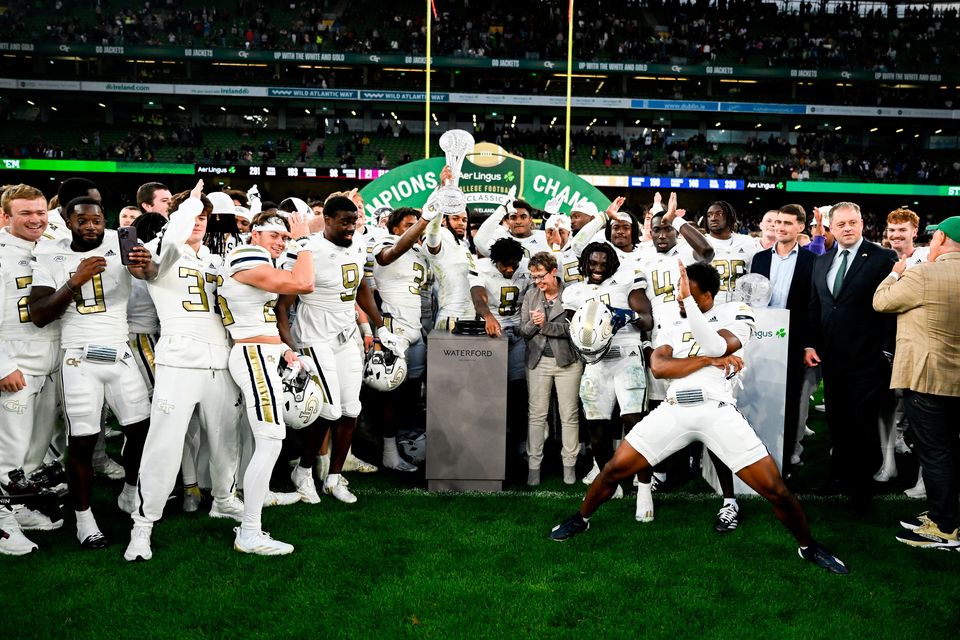 24 August 2024; Georgia Tech players celebrate with The Keough - Naughton College Football Ireland trophy during the 2024 Aer Lingus College Football Classic match between Florida State and Georgia Tech at Aviva Stadium in Dublin. Photo by Brendan Moran/Sportsfile 