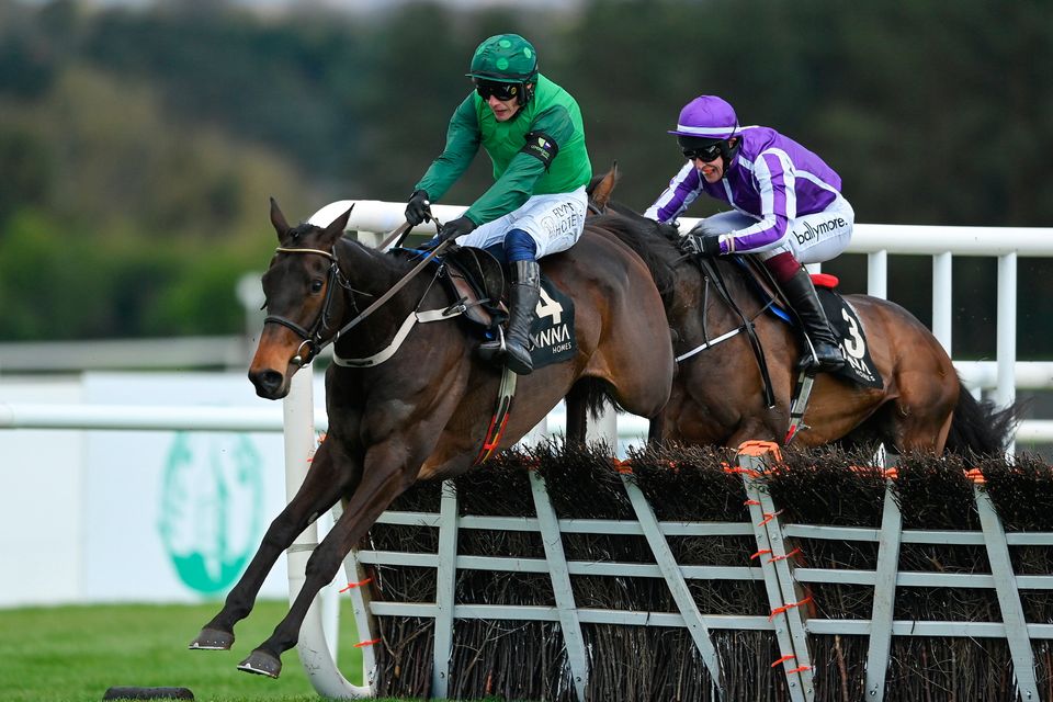 Impaire Et Passe, left, with Paul Townend up, jumps the last on their way to winning the Alanna Homes Champion Novice Hurdle, from second place High Definition, right, with JJ Slevin up, during day four of the Punchestown Festival