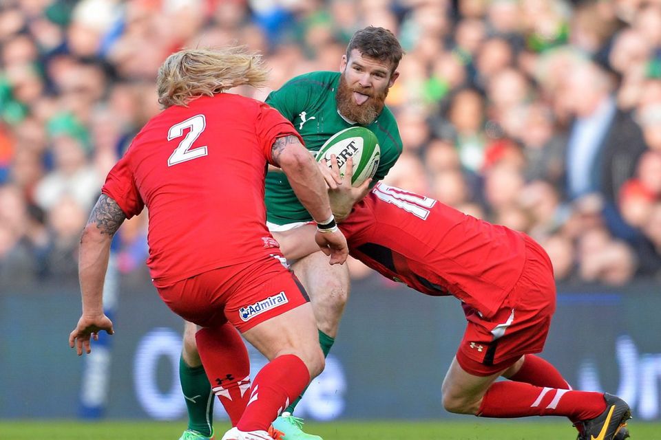 Gordon D'Arcy is tackled by Rhys Priestland and Richard Hibbard of Wales