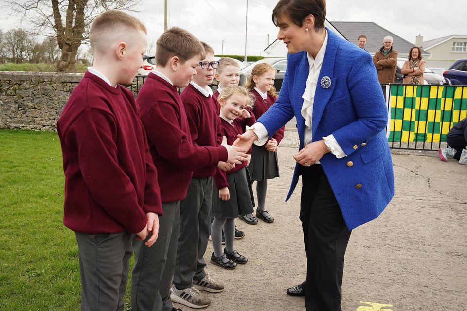 Students welcome Minister for Education Foley to Scoil Naomh Eirc Kilmoyley this past Monday for the official opening of the school's new 'outdoor classroom'.