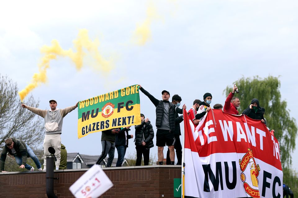 Fans holding up banners as they protest against the Glazer family, the owners of Manchester United, before their Premier League match against Liverpool was postponed. Picture: PA Wire/PA Images