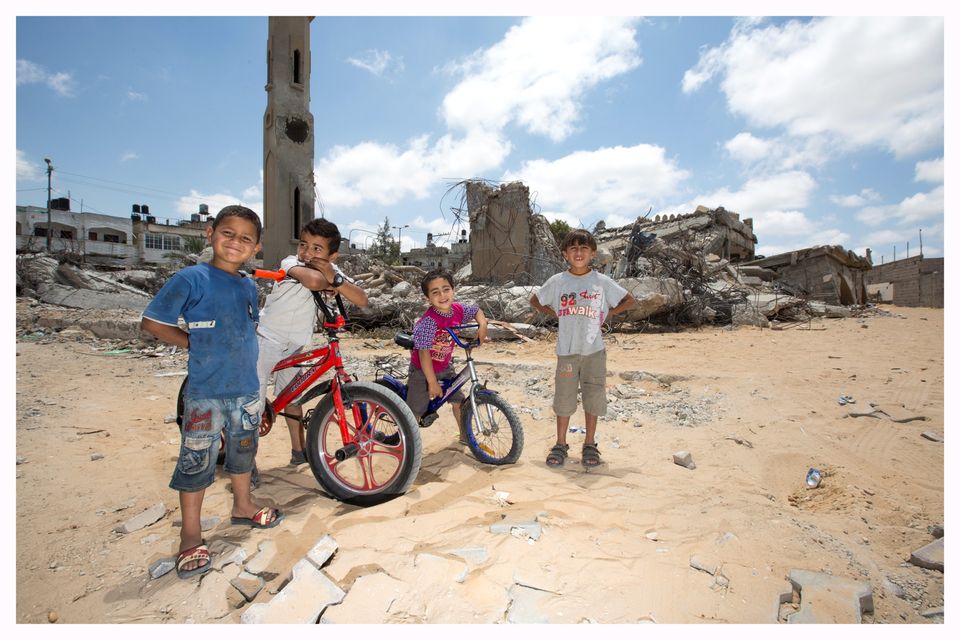 Children in front of a bombed out building in Gaza City.
Photo: Mark Condren