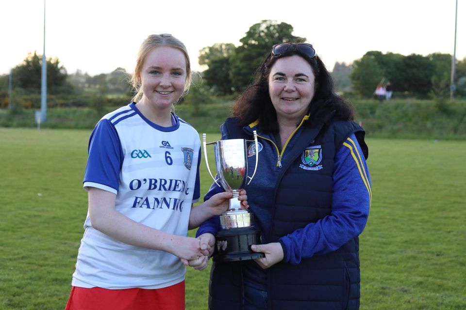 Wicklow Camogie's children's officer Nicki Flynn presents the Intermediate league cup to Aoife Campbell