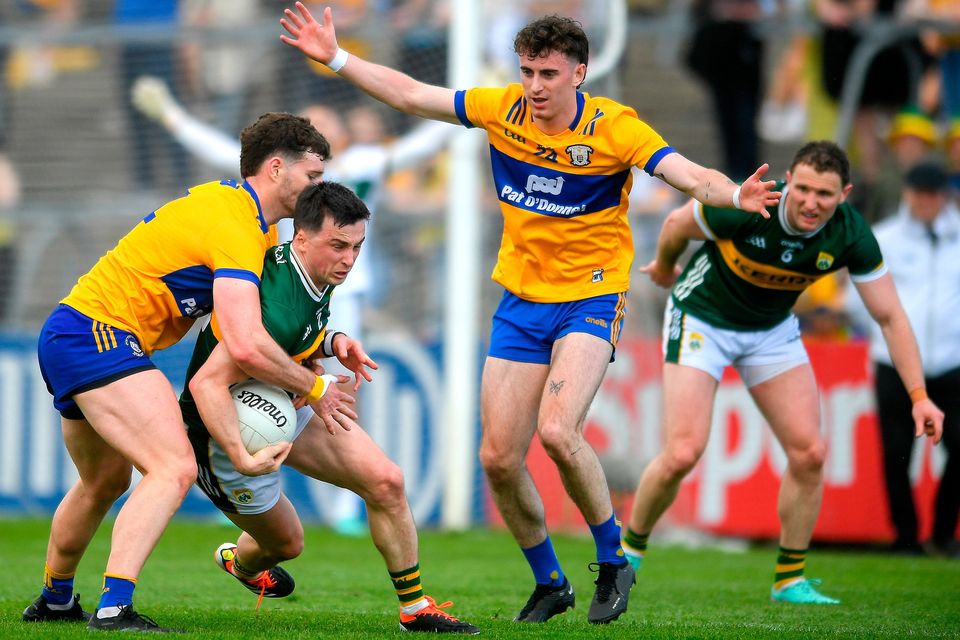 Kerry's Paul Murphy is tackled by Clare's Ronan Lanigan (left) during the Munster SFC final at Cusack Park in Ennis on Sunday. Photo: John Sheridan/Sportsfile