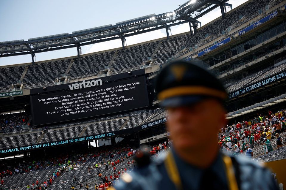 A screen displays a message to the fans as the match is suspended due to adverse weather