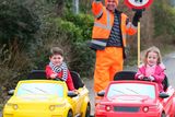 thumbnail: Local lollipop man, David Mitchell from St. Andrews National School, Asbourne, Co.Meath with Twins Conor and Tara Ocks - the first children to try out the cars featured at the Nissan Driving School at Tayto Park, when it launched this year. Photo: Leon Farrell/Photocall Ireland.