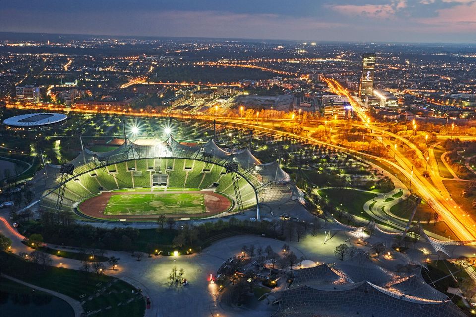 Aerial view of Munich's Olympic stadium illuminated at night. Stock photo/Getty