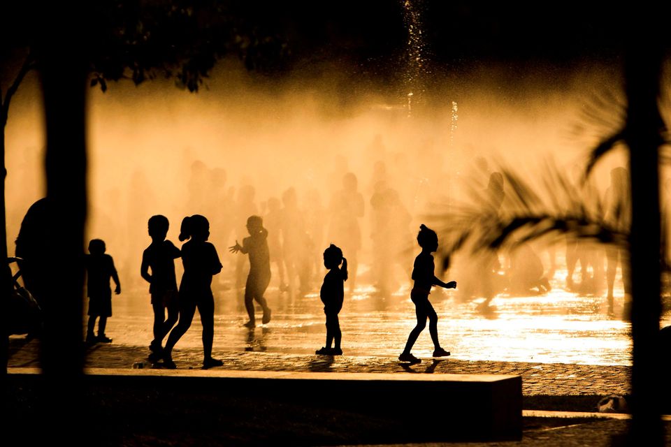 Children play as they cool down in a fountain beside the Manzanares river in Madrid. Photo: AP