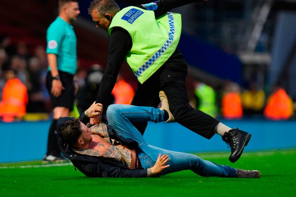 A steward takes down a fan after he runs on the pitch during the Carabao Cup Second Round match between Blackburn Rovers and Burnley at Ewood Park on August 23, 2017 in Blackburn, England. (Photo by Nathan Stirk/Getty Images)