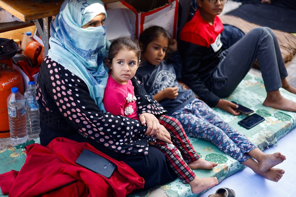 Palestinians who fled their houses amid Israeli strikes take shelter in a United Nations-run school, after Israel's call for more than 1 million civilians in northern Gaza to move south, in Khan Younis in the southern Gaza Strip. Photo: Reuters