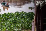 thumbnail: A young boy rides his boat in the floating village