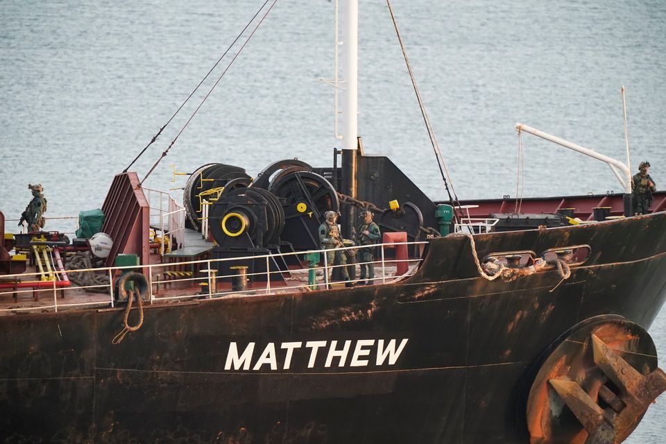 Military personnel on board the MV Matthew as it is escorted into Cork Harbour by the Irish Naval Service. Photo: Niall Carson/PA